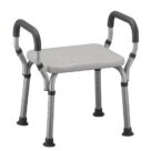 A white shower chair with black handles.