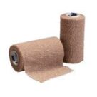 A roll of bandage is next to another roll.