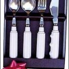 A set of four white silverware in a box.