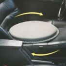 A car seat with the steering wheel on top of it.
