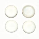 A set of four white buttons sitting on top of a table.